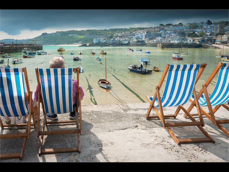 Beach chairs in a harbour.